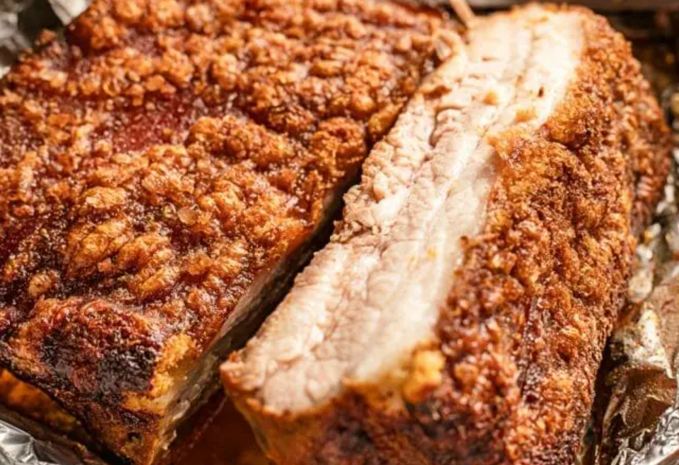 Crispy smoked pork belly with crackling skin and a juicy sliced interior