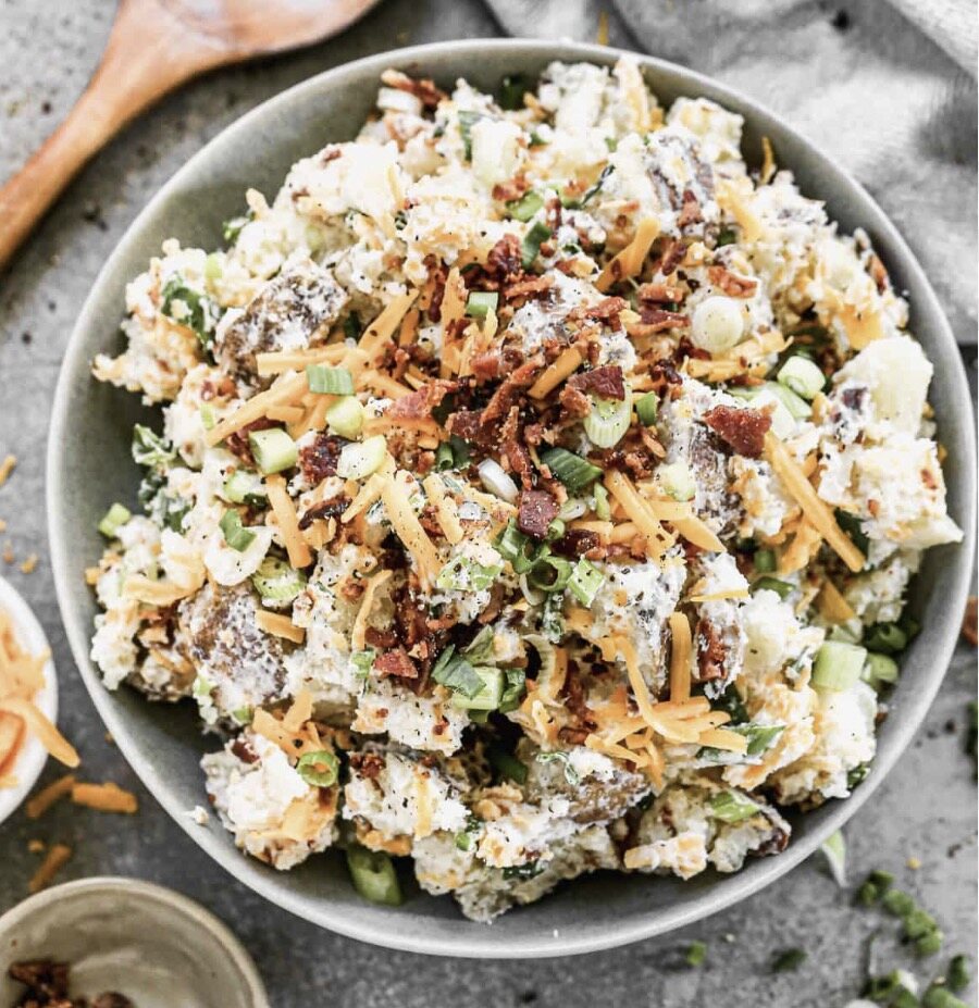 Representative serving of loaded potato salad with bacon, cheddar and green onion