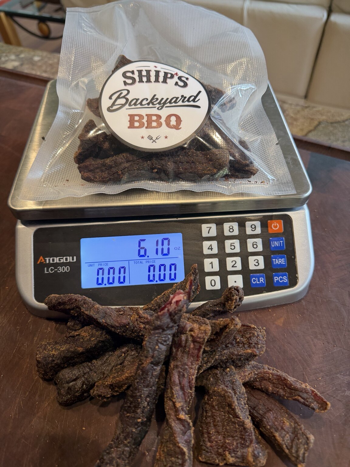 Package of Ship's Beef Jerky with additional jerky pieces