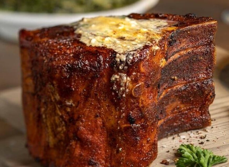 Representative three-bone smoked pork chop with a seasoned crust